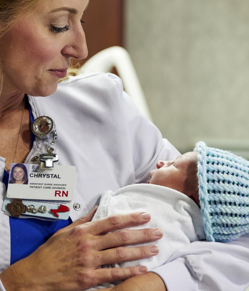 Close-up of female nurse holding newborn baby